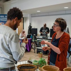 A young male learning about gardening at a tenant event