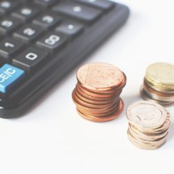 Photo of a calculator and some coins