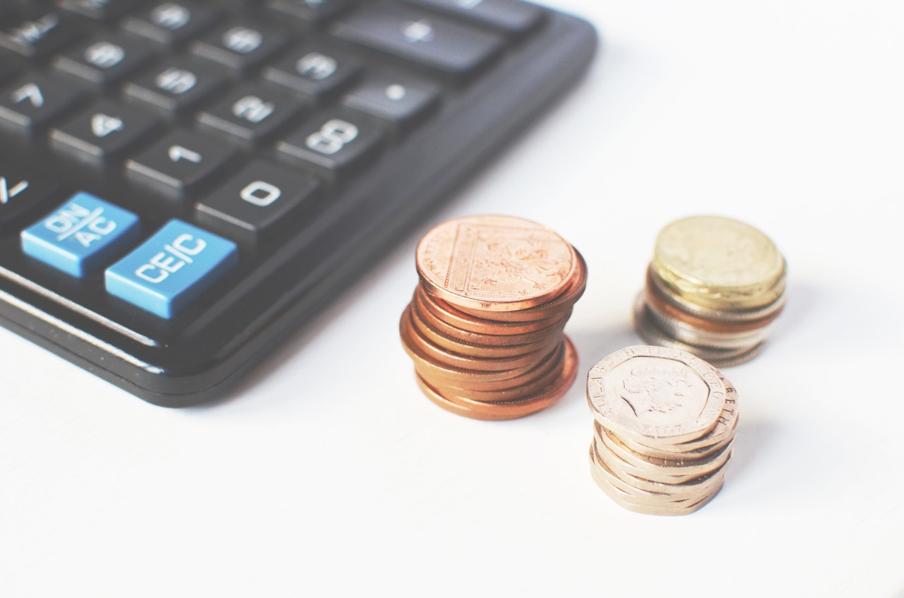 Photo of a calculator and some coins