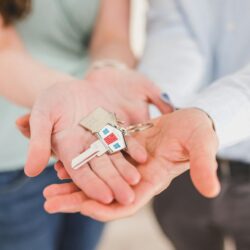 Person holding a set of door keys